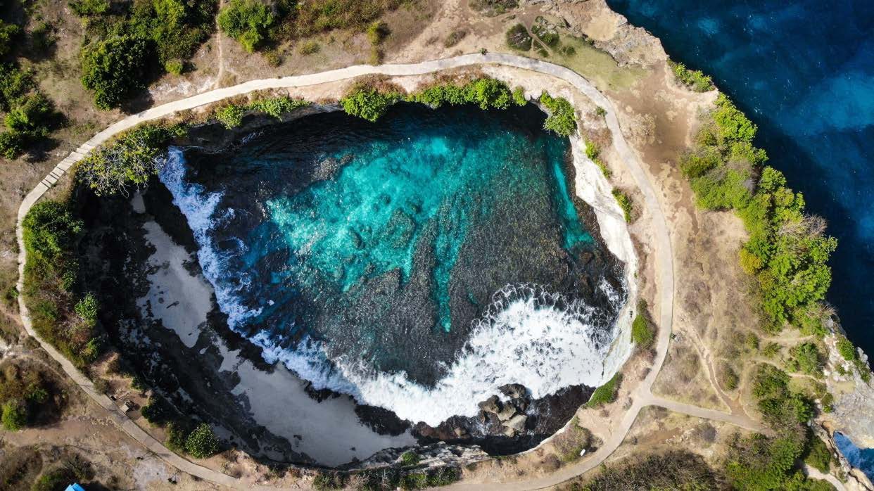 The cliffs and turquoise shallows of Nusa Penida from directly above